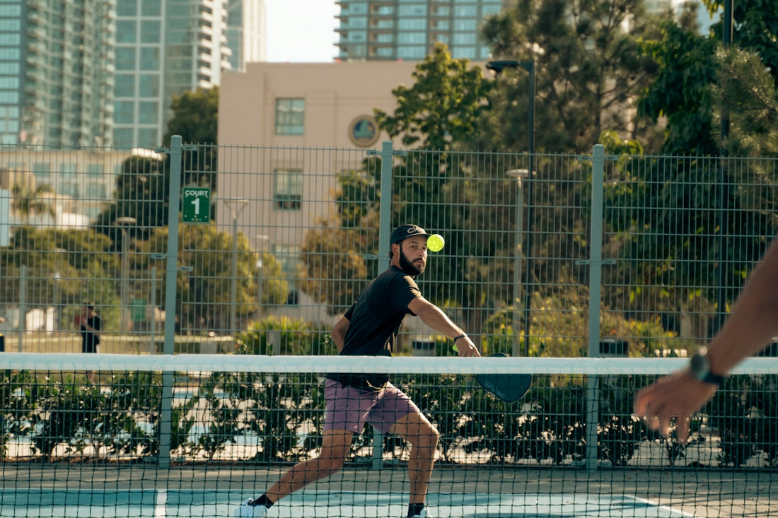Two men playing tennis on a tennis court