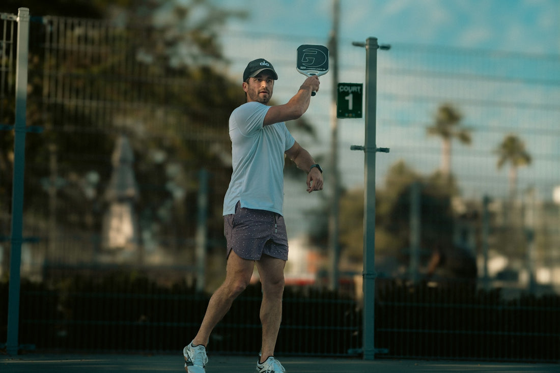 A man standing on a tennis court holding a racquet
