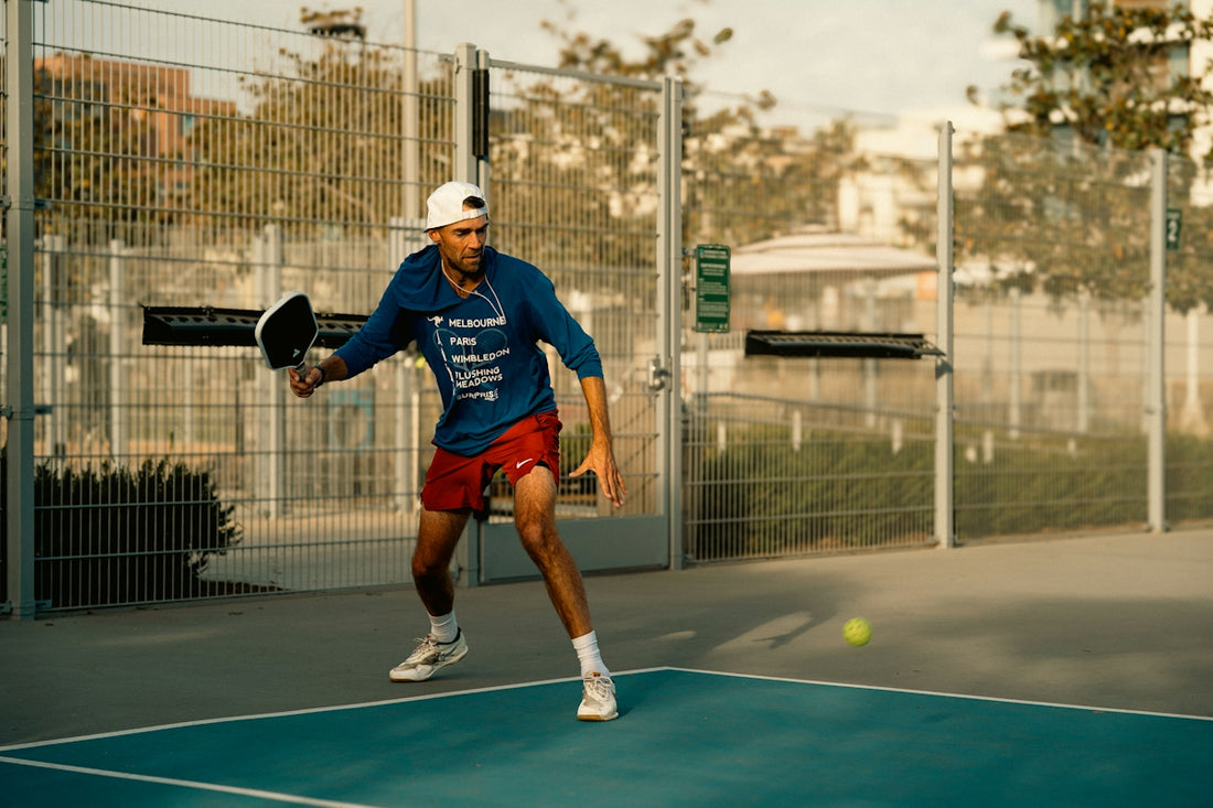 A man holding a tennis racquet on a tennis court