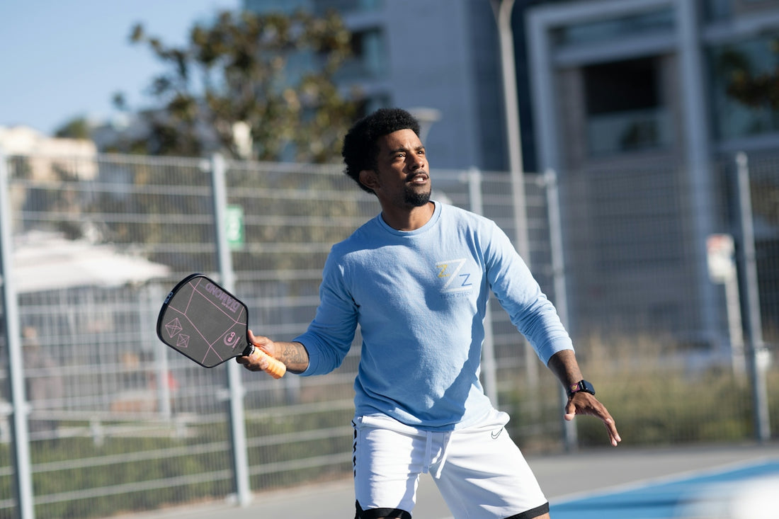 A man holding a tennis racquet on a tennis court