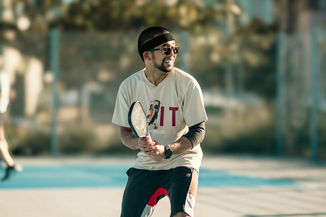 A man holding a tennis racquet on top of a tennis court
