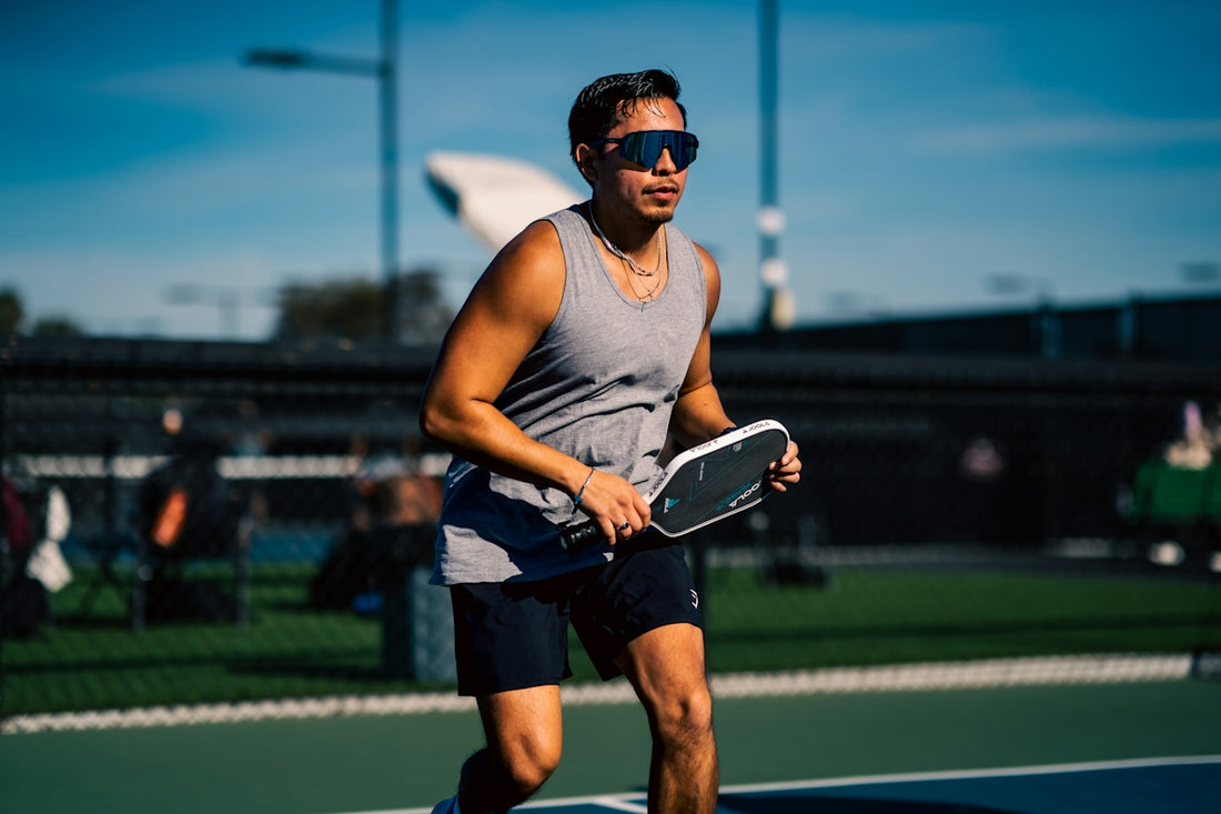 A man holding a tennis racquet on a tennis court